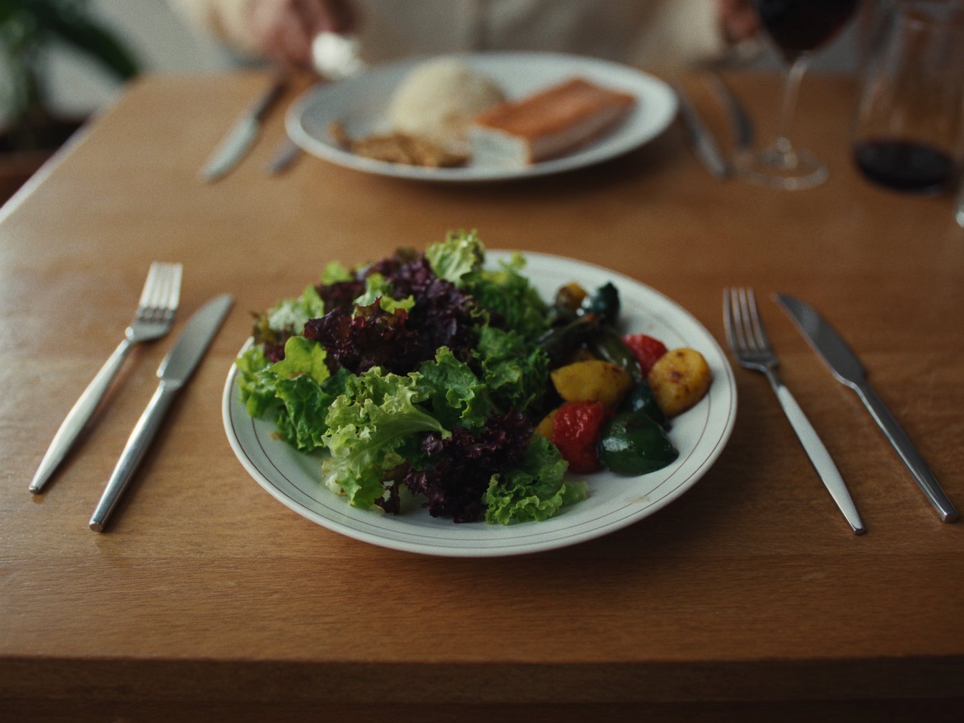 A balanced plate with greens and protein eaten first to lower the blood sugar spike
