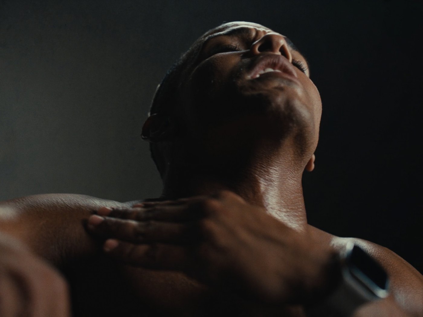 Athlete catching their breath mid workout with a smartwatch on the wrist